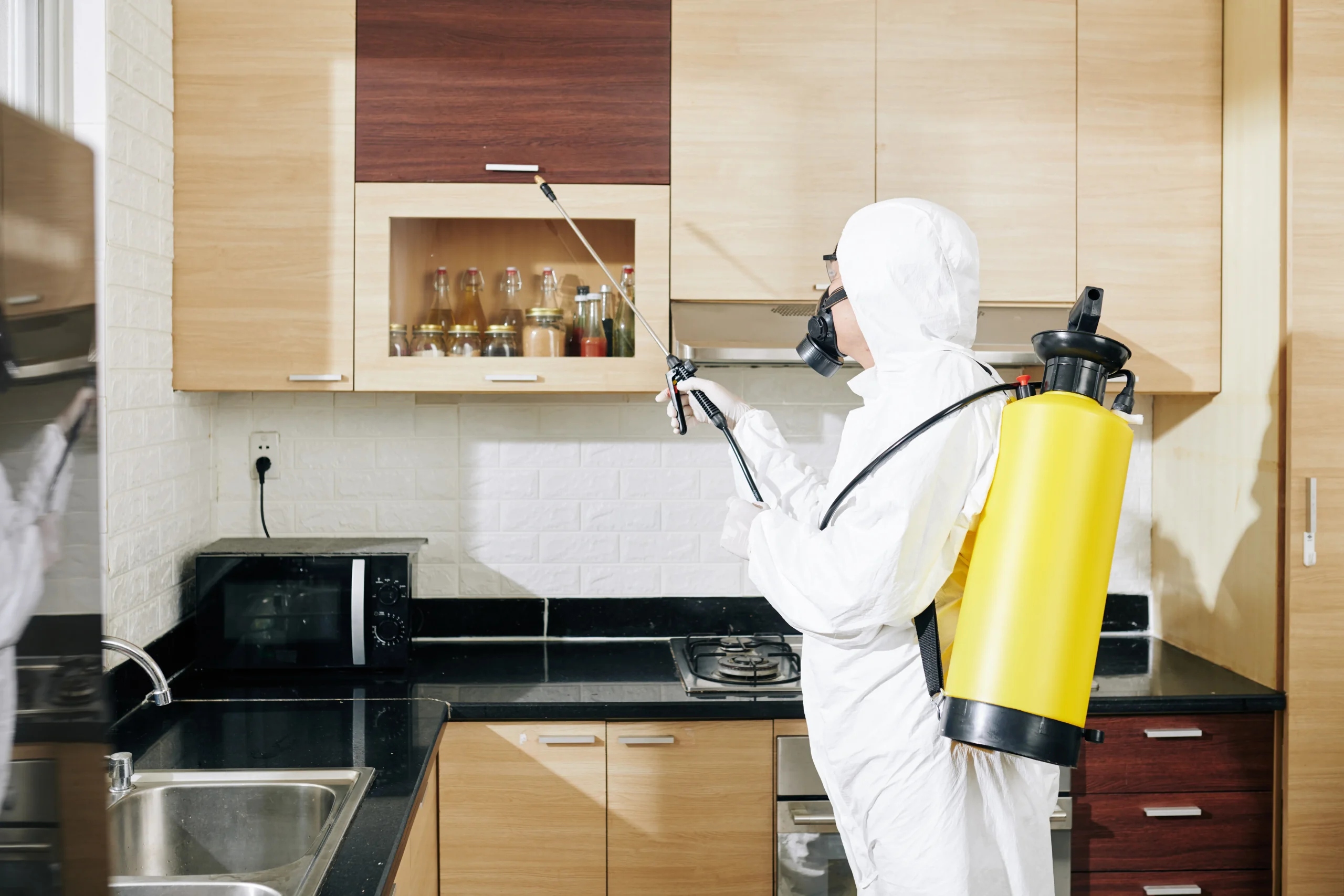 worker-hazmat-suit-applying-spray-surfaces