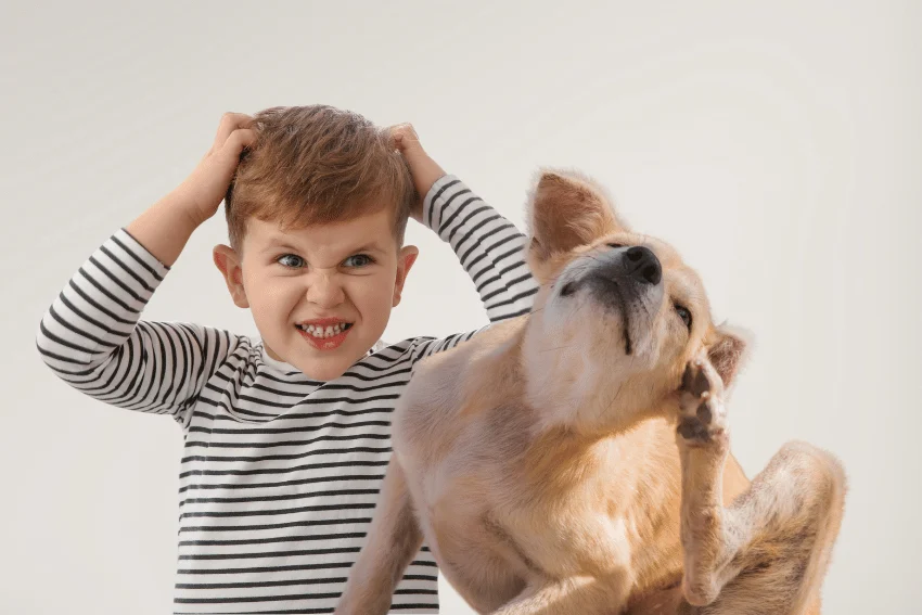 Child and dog scratching their heads